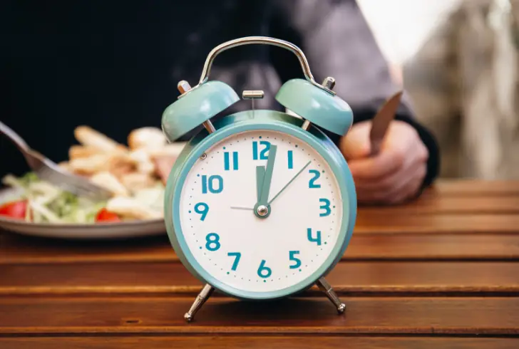 Clock with person eating at late night